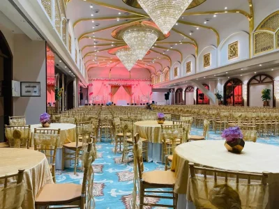 Decorated wedding hall in Thane with gold chairs and chandeliers