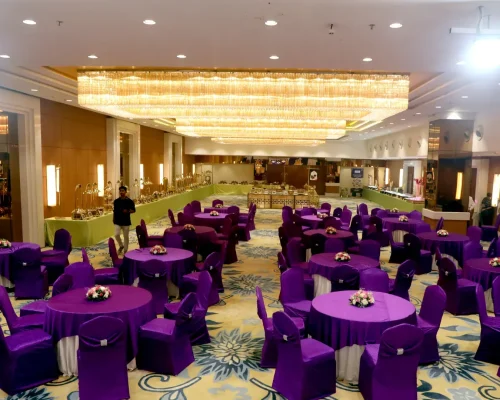 Decorated banquet hall in Thane West with purple table setup