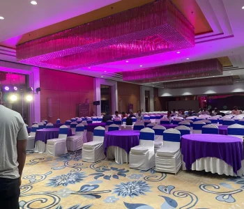 Spacious corporate event venue with round table setup